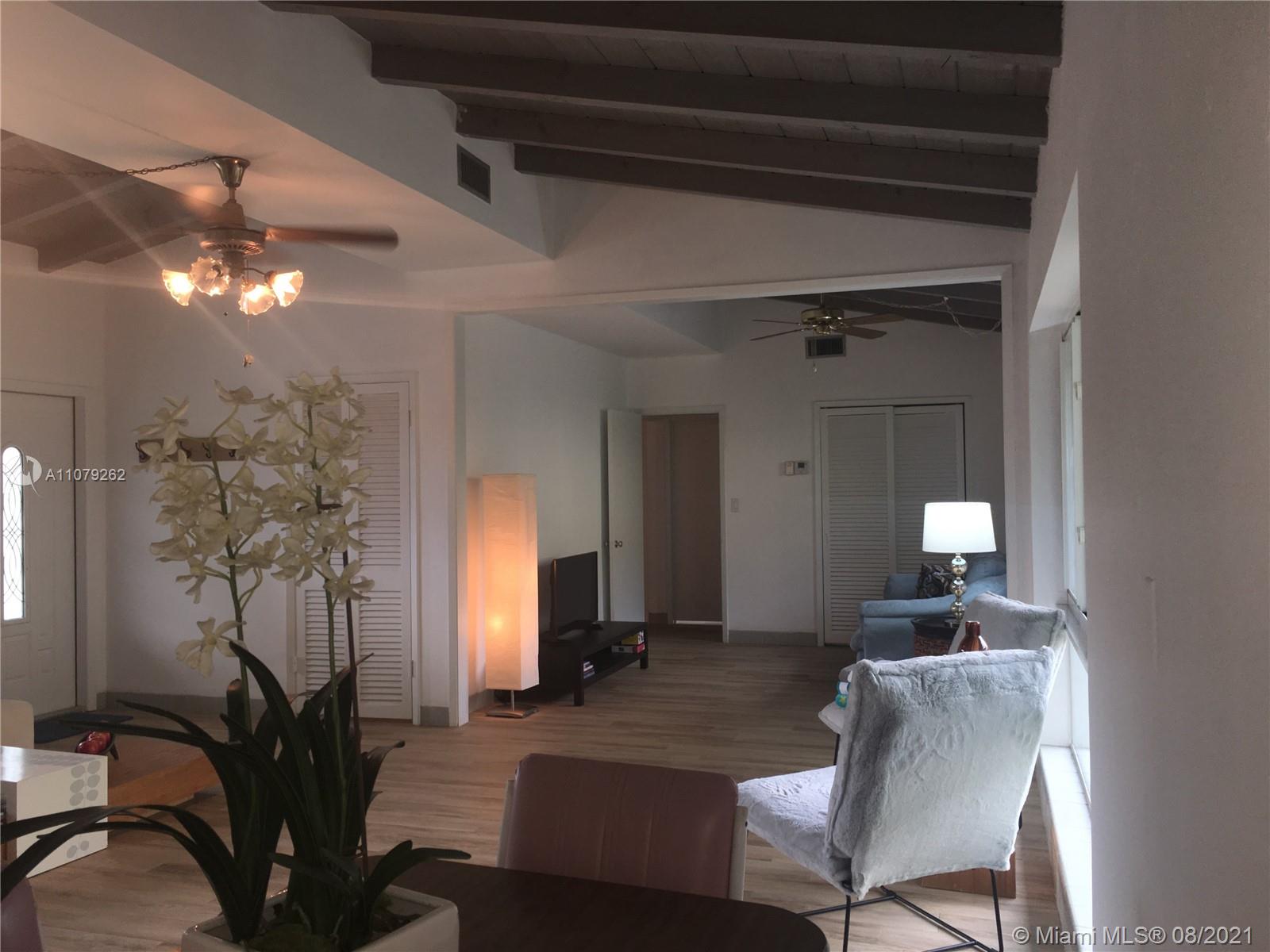 524 North Riverside Drive Pompano Beach, FL 33062 - Photo 5 of 35 a living room with furniture and a chandelier