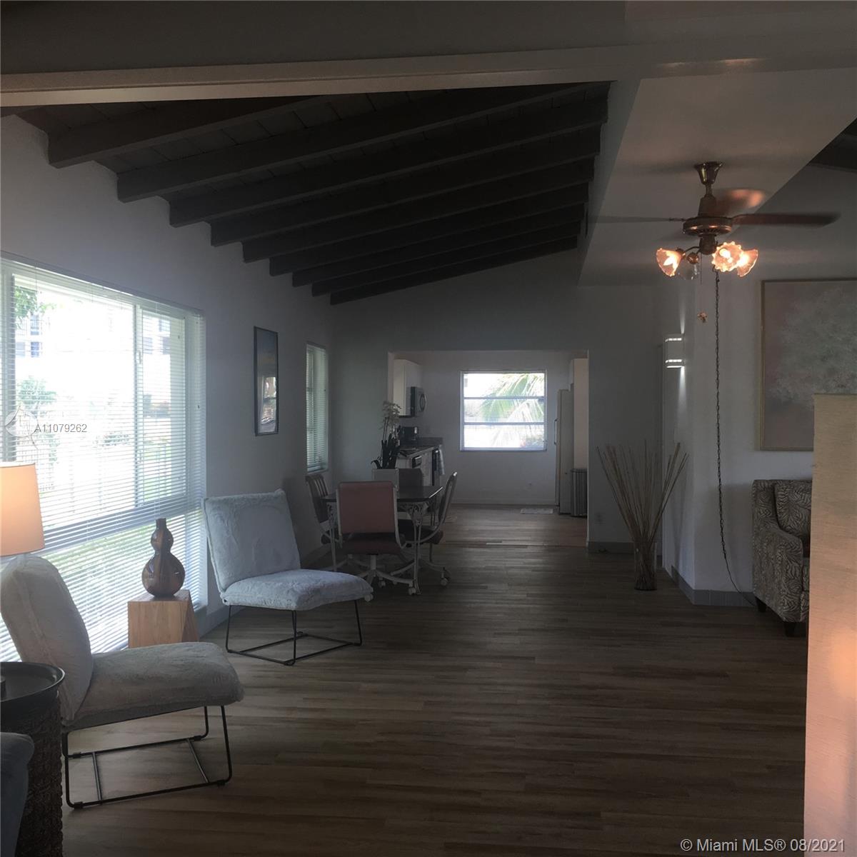 524 North Riverside Drive Pompano Beach, FL 33062 - Photo 8 of 35 a living room with furniture and a chandelier