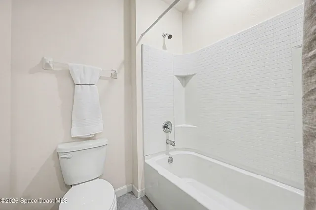 a bathroom with a toilet and a bathtub