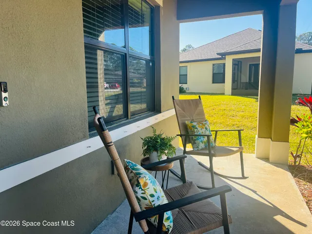 a view of a chairs and table in the balcony