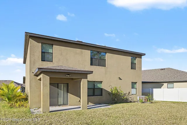 a view of a house with small yard