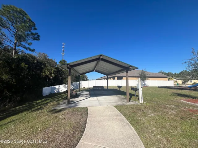 a view of a backyard with sitting area