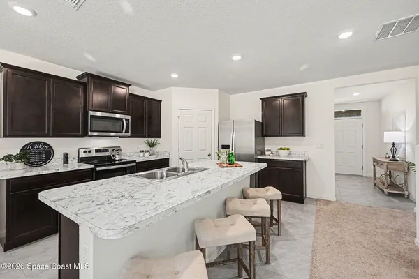 a kitchen with a stove a sink and a refrigerator