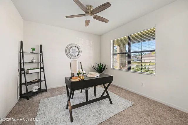 a view of a workspace with furniture