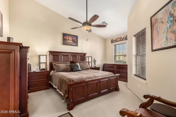 a bedroom with a bed dresser and a window