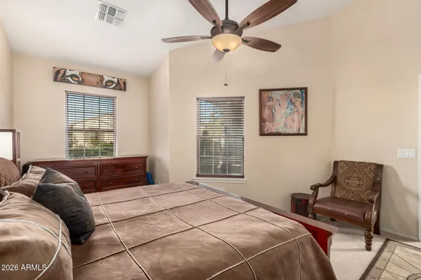 a bedroom with a bed couches and window