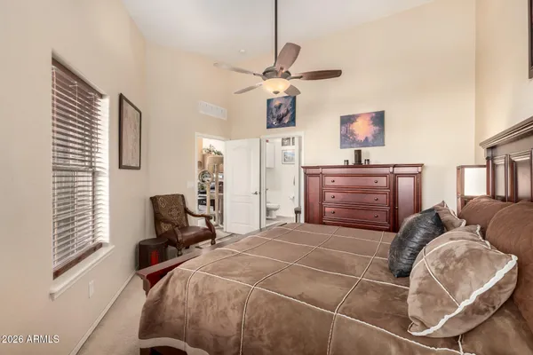 a bedroom with a bed dresser and window