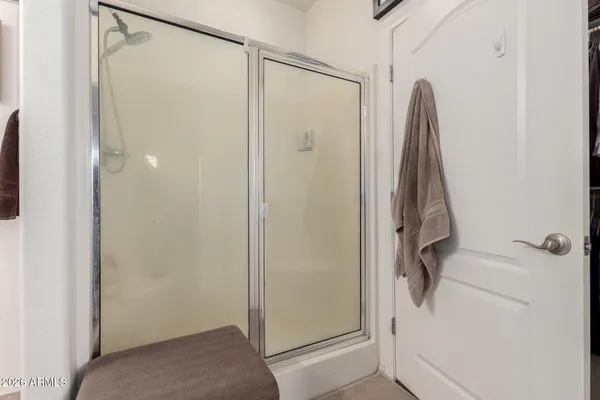 a bathroom with a shower and a glass door