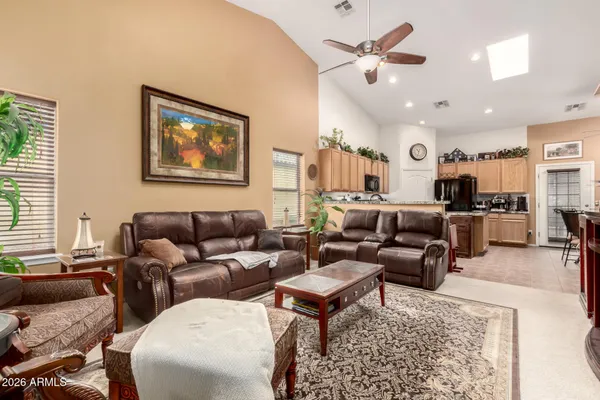 a living room with furniture a rug and a chandelier