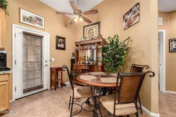 a view of a dining room with furniture and a window