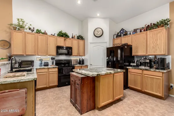 a kitchen with a stove top oven and a refrigerator