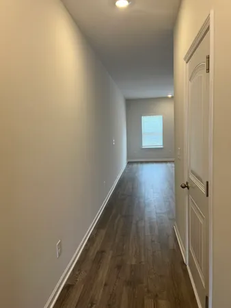a view of a room with wooden floor and window