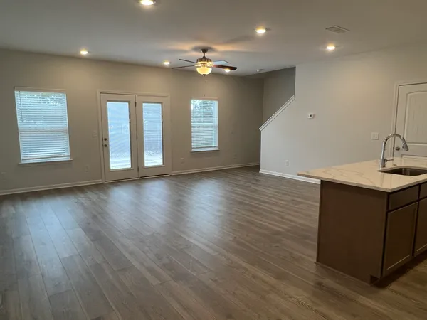 a kitchen with a refrigerator sink and cabinets