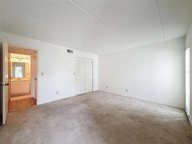 a view of an empty room and closet area