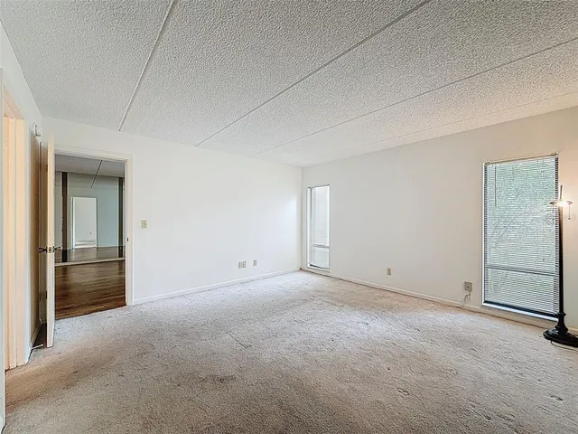 a view of an empty room and a window