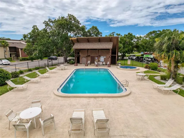 a view of swimming pool with seating area
