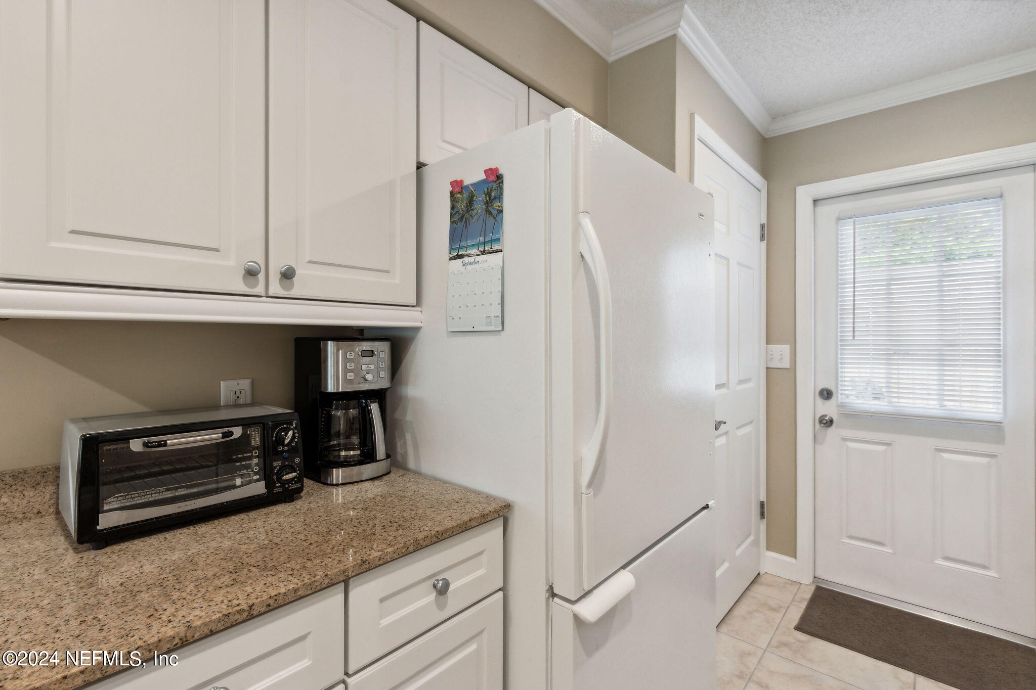 3327 Sea Marsh Road Fernandina Beach, FL 32034 - Photo 7 of 39 a kitchen with granite countertop a refrigerator and a sink