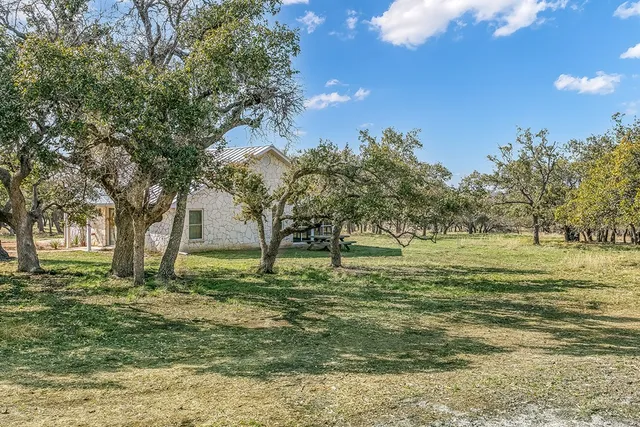 a large yard with lots of green space and trees