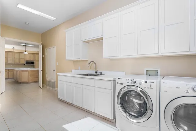 a view of a kitchen with sink washer and dryer