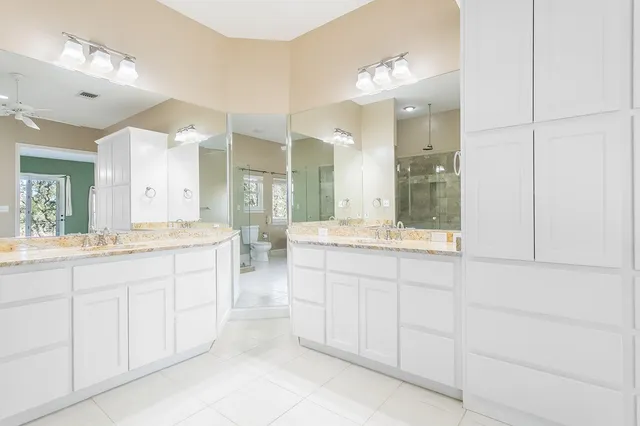 a bathroom with a double vanity sink and a mirror