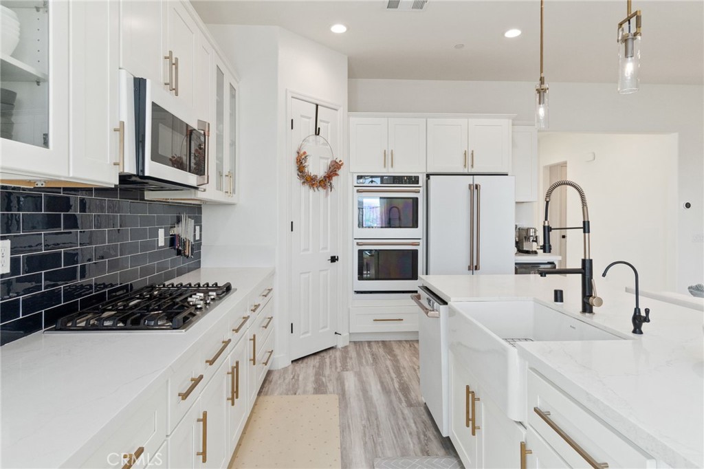 2308 Nova Way Corona, CA 92883 - Photo 11 of 32 a kitchen with stainless steel appliances a sink a stove and cabinets