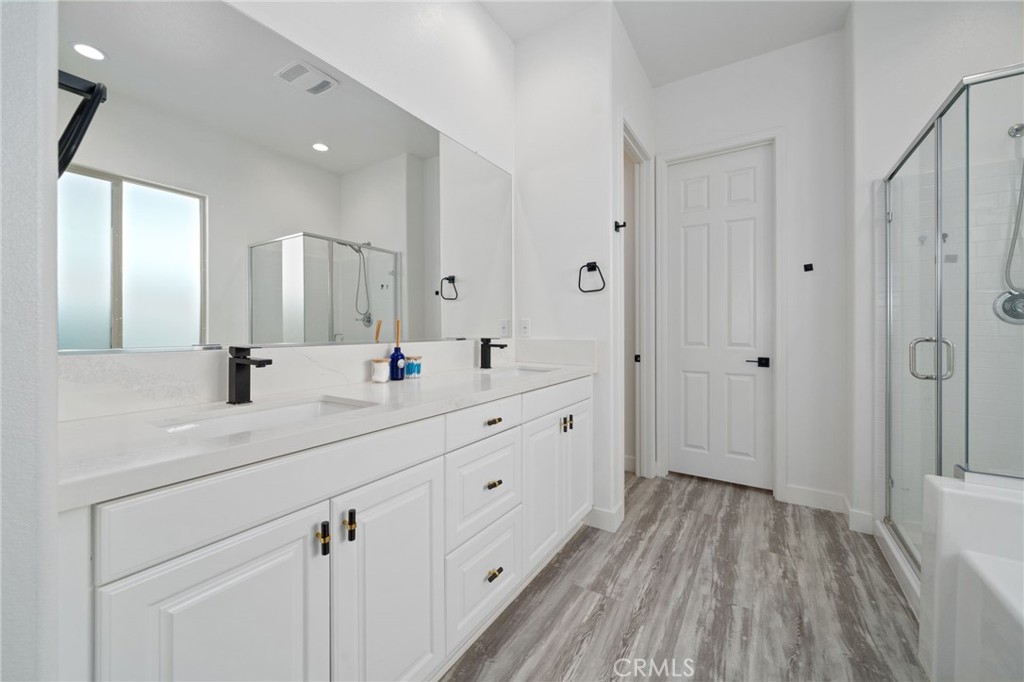 2308 Nova Way Corona, CA 92883 - Photo 16 of 32 a spacious bathroom with a double vanity sink and mirror