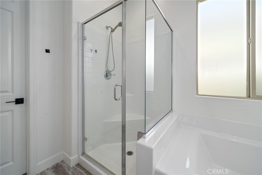 2308 Nova Way Corona, CA 92883 - Photo 17 of 32 a bathroom with a bathtub and a shower
