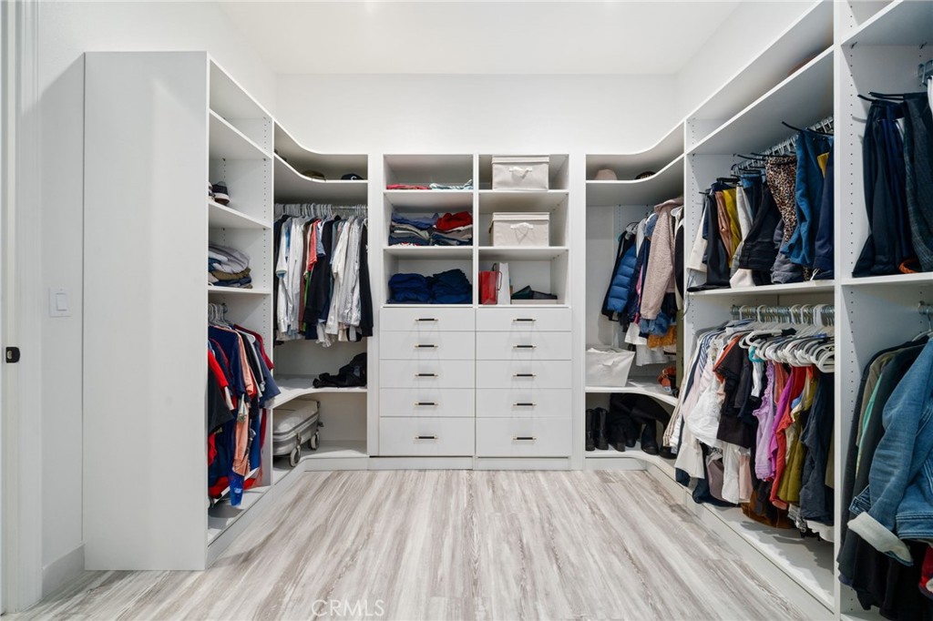 2308 Nova Way Corona, CA 92883 - Photo 19 of 32 a view of walk in closet with clothes and shoes
