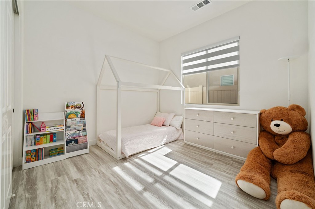 2308 Nova Way Corona, CA 92883 - Photo 22 of 32 a bedroom with a bed and cabinets