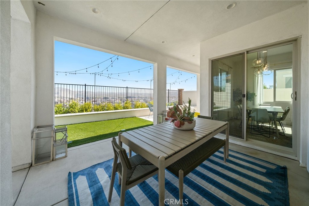 2308 Nova Way Corona, CA 92883 - Photo 28 of 32 a room with wooden floor table and chairs