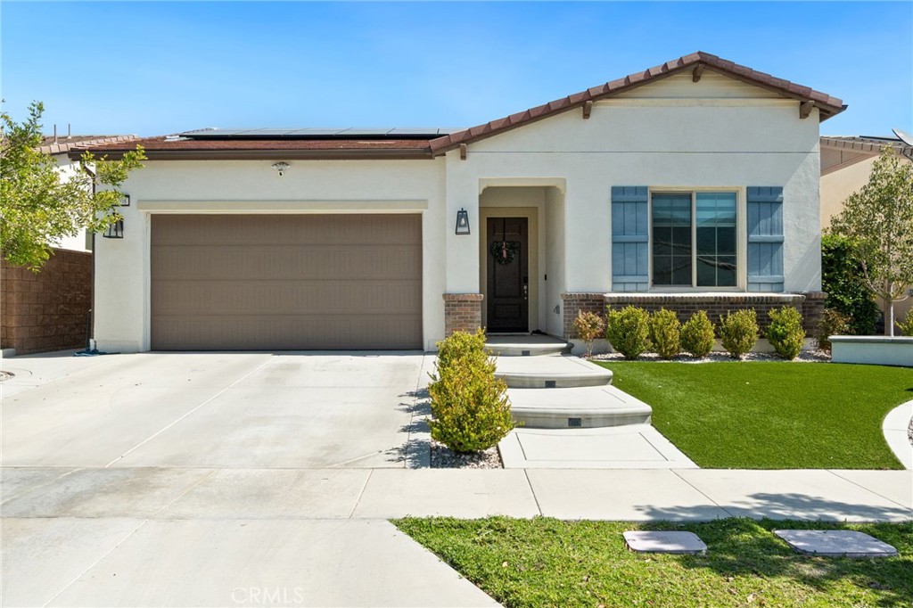 2308 Nova Way Corona, CA 92883 - Photo 3 of 32 a front view of a house with a yard and garage