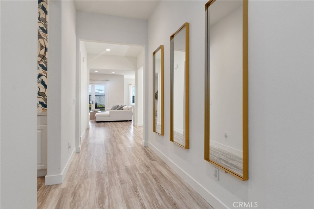2308 Nova Way Corona, CA 92883 - Photo 4 of 32 a view of a hallway with wooden floor windows and a bathroom