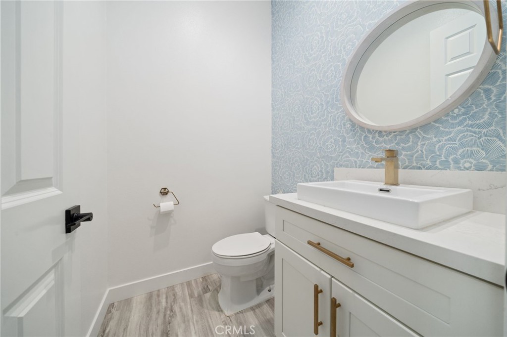 2308 Nova Way Corona, CA 92883 - Photo 6 of 32 a bathroom with a sink a toilet and a mirror