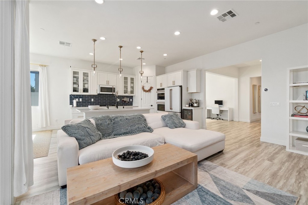 2308 Nova Way Corona, CA 92883 - Photo 9 of 32 a living room with furniture and a wooden floor