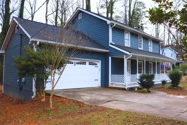 a view of a entrance gate of a house with wooden fence