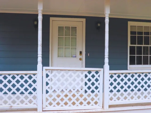 a view of a room with wooden floor and windows