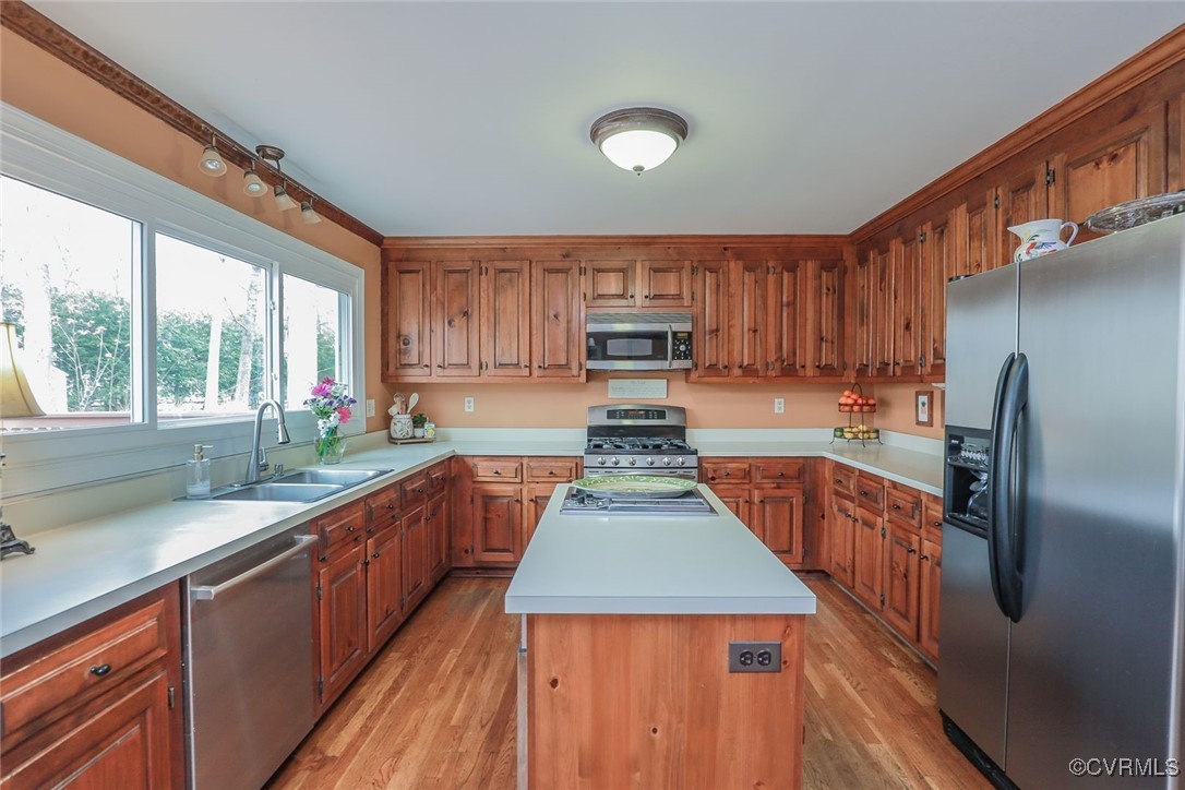 2400 Olde Stone Road Midlothian, VA 23113 - Photo 12 of 48 a kitchen with kitchen island granite countertop wooden cabinets a sink and a stove