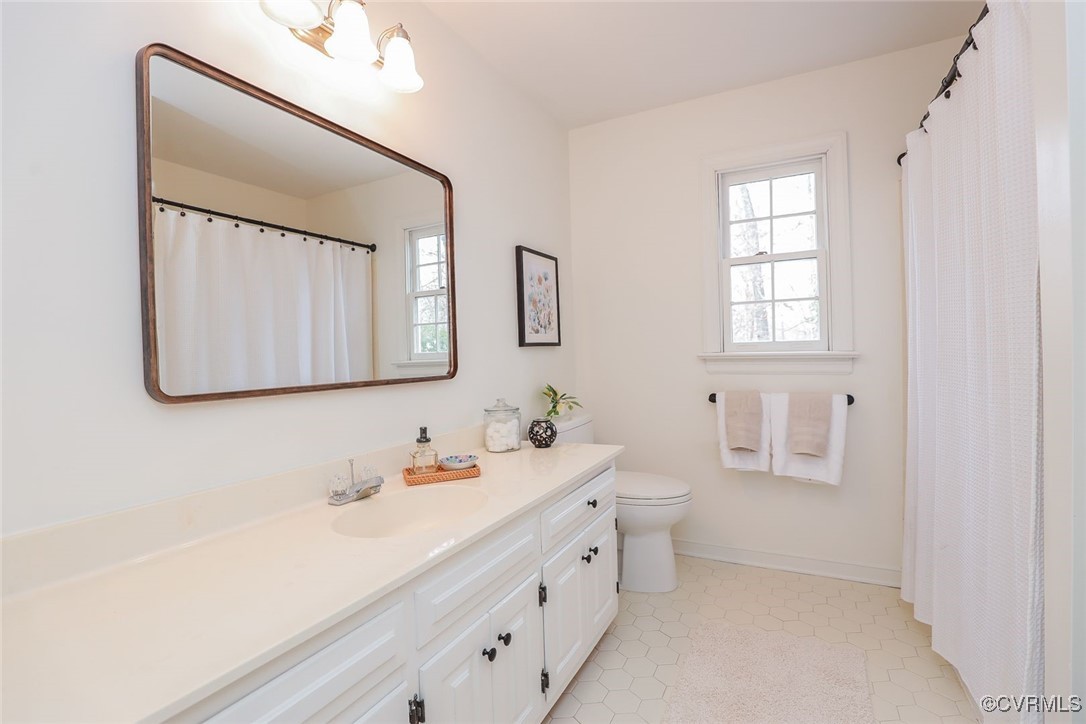 2400 Olde Stone Road Midlothian, VA 23113 - Photo 35 of 48 a bathroom with a double vanity sink mirror and bathtub