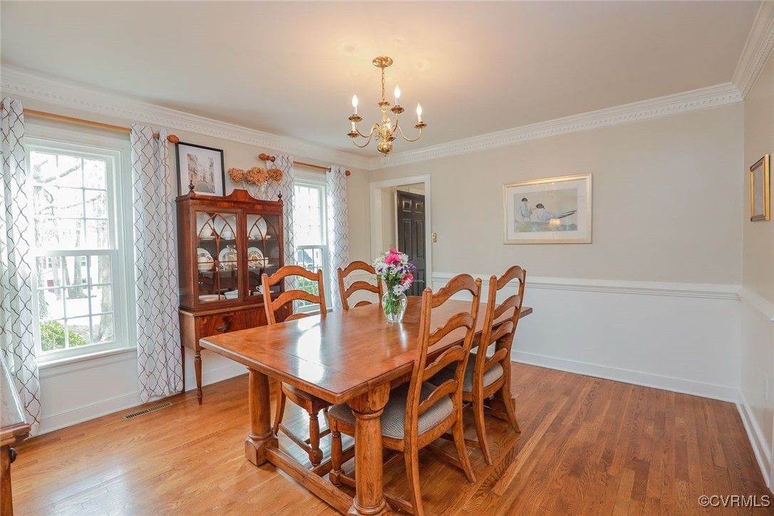 2400 Olde Stone Road Midlothian, VA 23113 - Photo 6 of 48 a dining room with furniture a chandelier and wooden floor