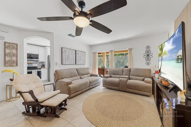 a living room with furniture and a large window