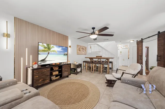 a living room with furniture and a flat screen tv