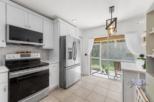 a kitchen with stainless steel appliances a stove a microwave and a refrigerator