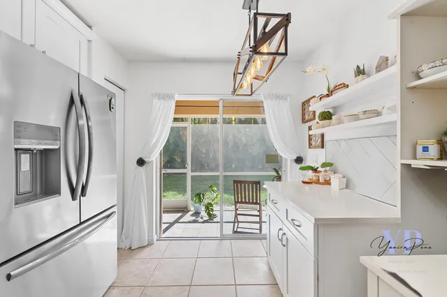 a kitchen with a refrigerator and a sink
