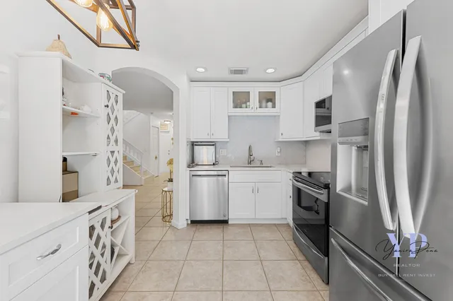 a kitchen with a refrigerator sink and stove