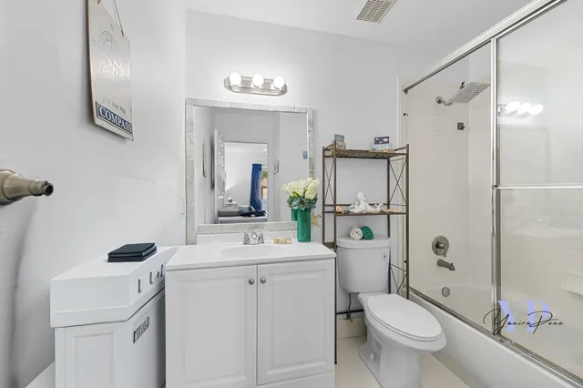a bathroom with a sink toilet tub and shower