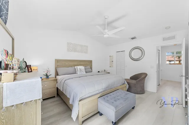 a bedroom with a bed and ceiling fan