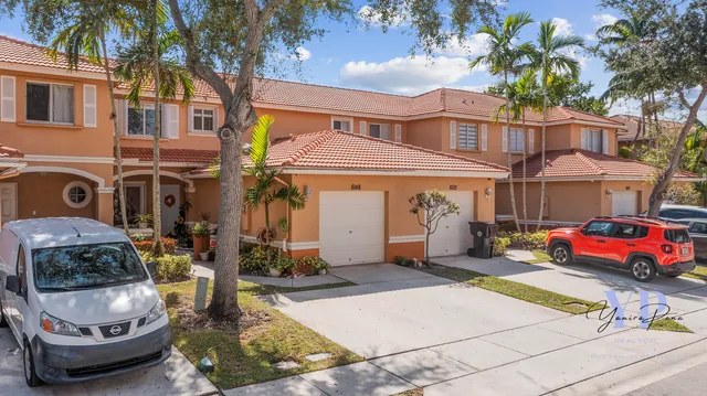 a front view of a house with swimming pool and glass windows