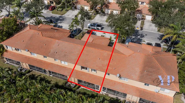 an aerial view of a tennis ground with large trees