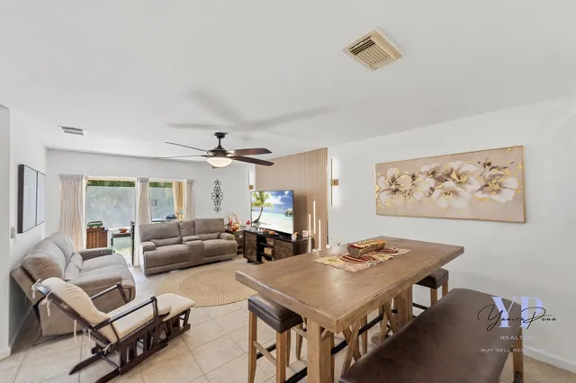 a view of a dining room with furniture and a chandelier