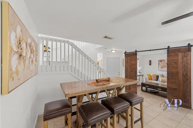a dining room with furniture and wooden floor